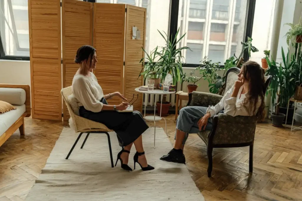 female client during individual therapy together with a female psychologist in addiction treatment center in corona california