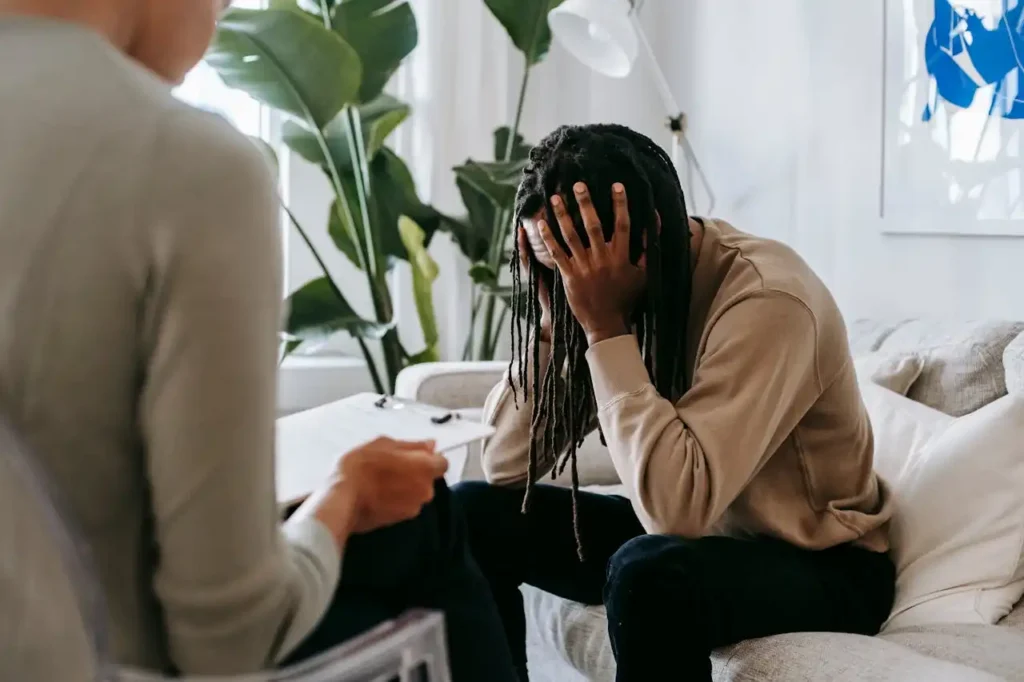A concerned client in therapy, seeking professional support and guidance indoors
