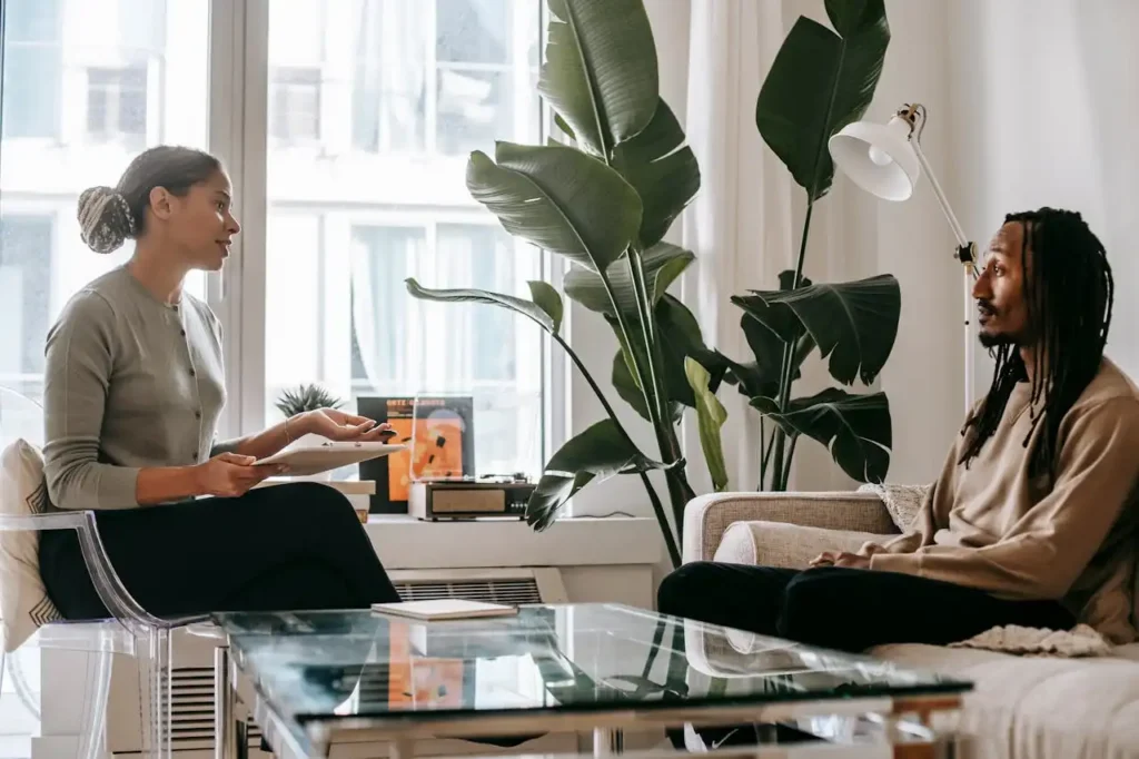 A thoughtful therapy session between a psychologist and a client in a modern office setting understanding heroin detox at West Coast Detox