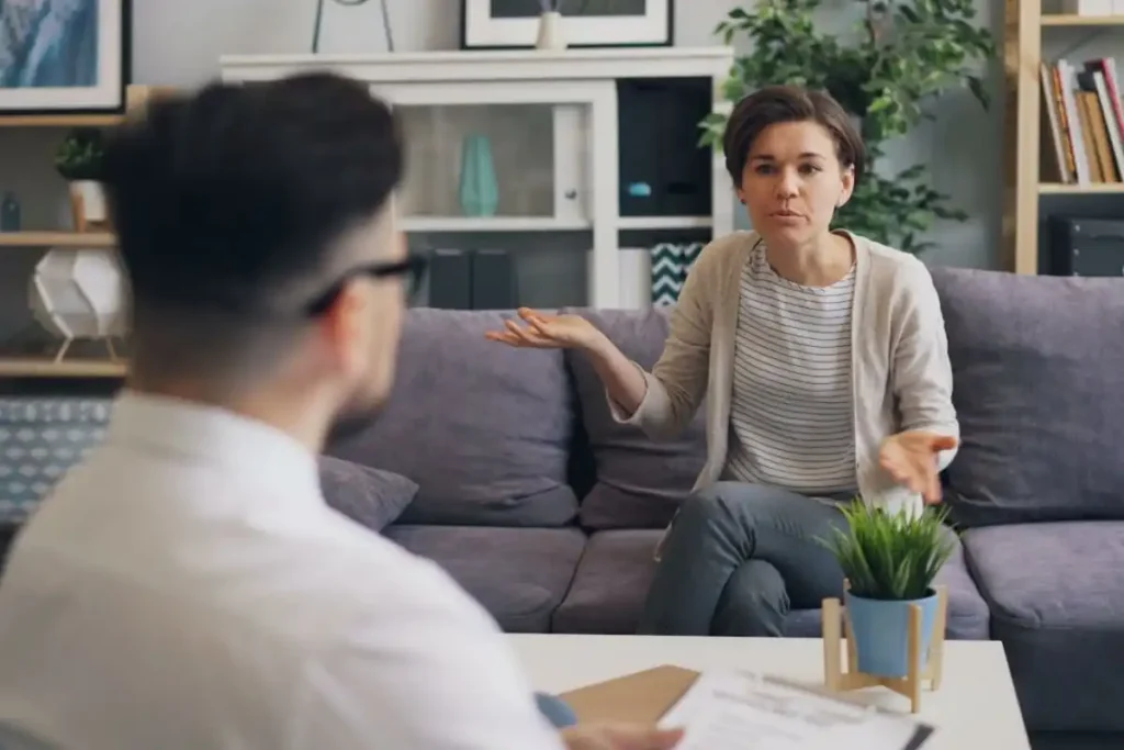 A woman consulting with a professional therapist in a modern office setting
