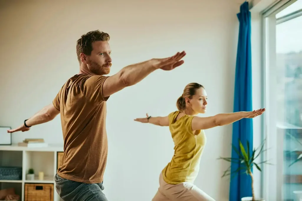 a couple doing yoga in drug and alcohol rehab center in corona southern california riverside