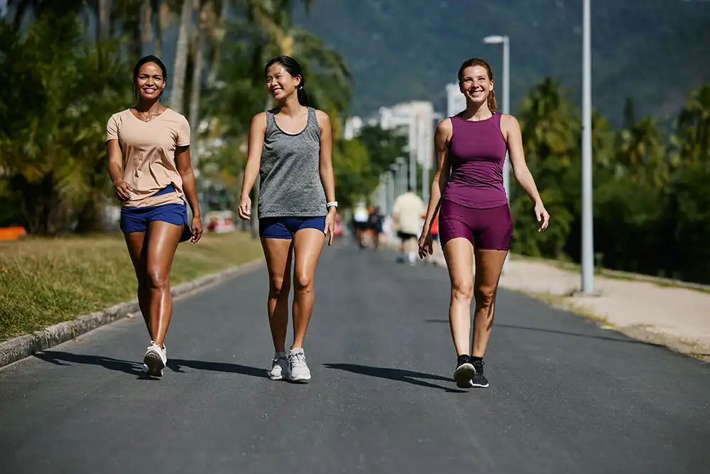 three women walking doing some exercises in southern california