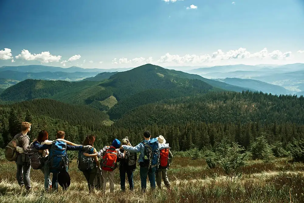 a community support embracing each other during hiking