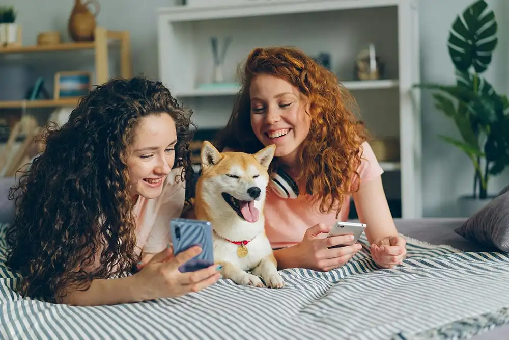 two women in recovery together with a dog as part of their holistic treatment