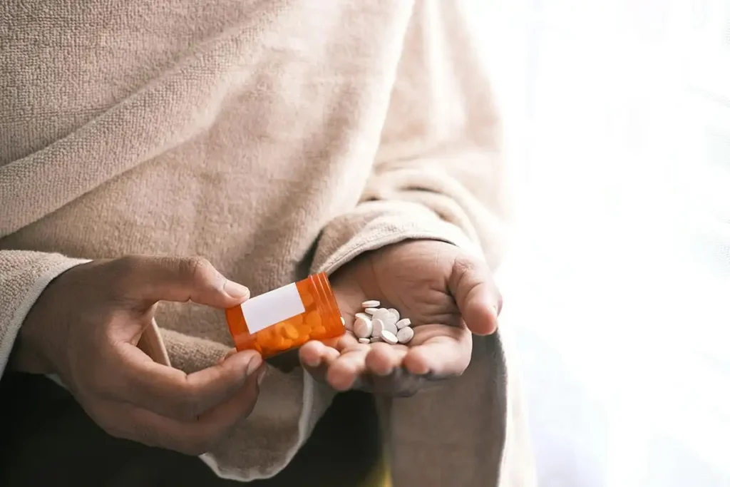 white pills on woman's hand