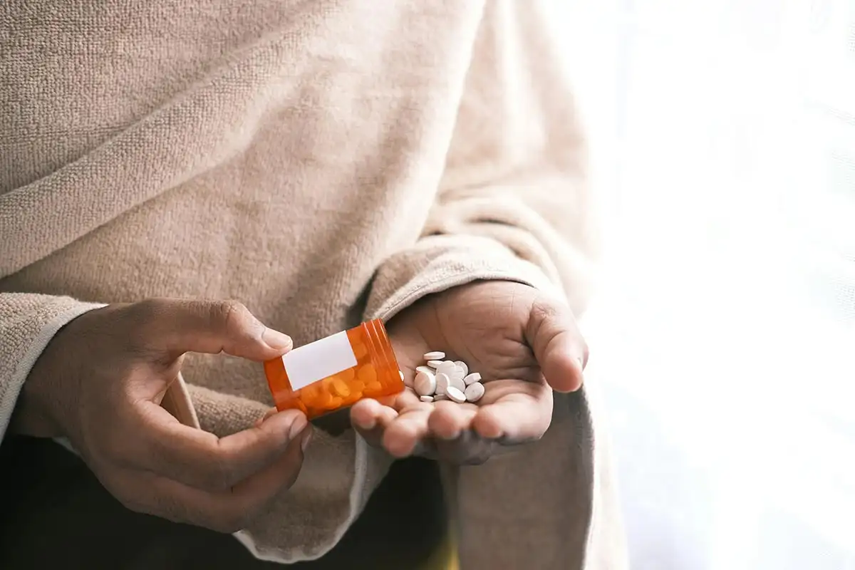 white pills on woman's hand