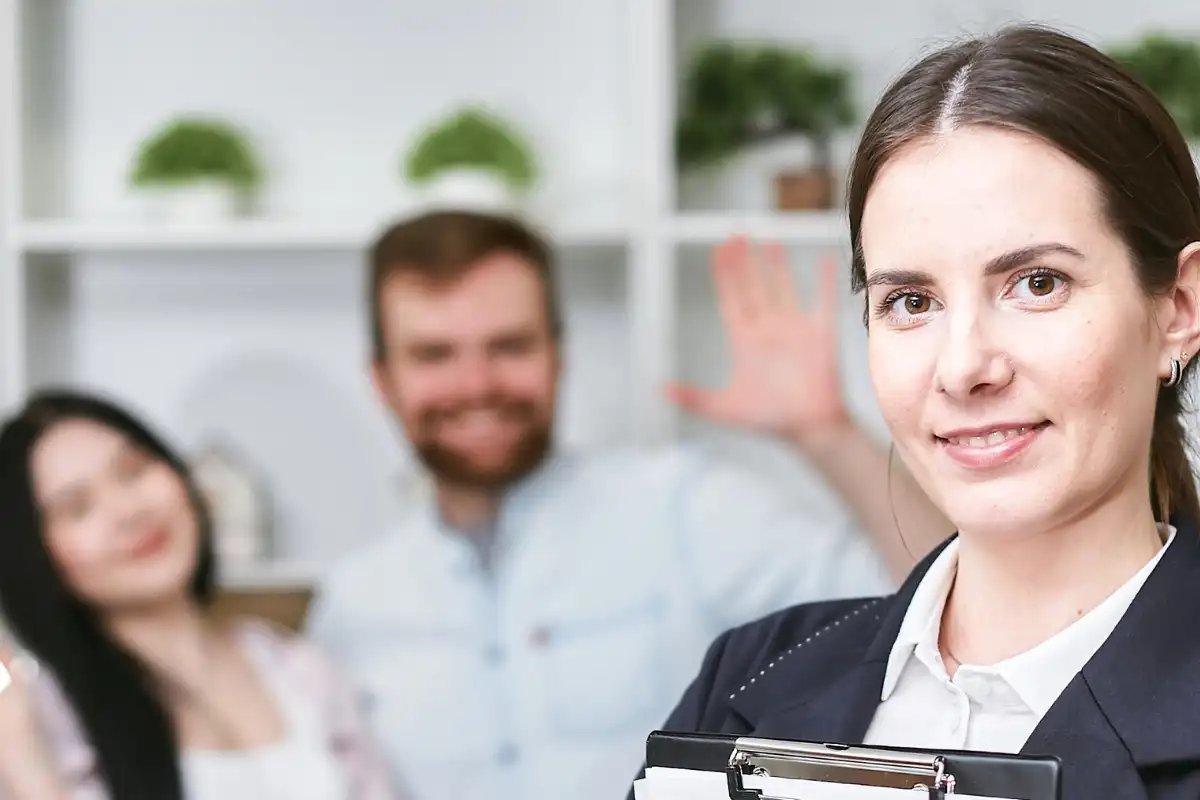 A Woman Smiling and Holding an Insurance plan