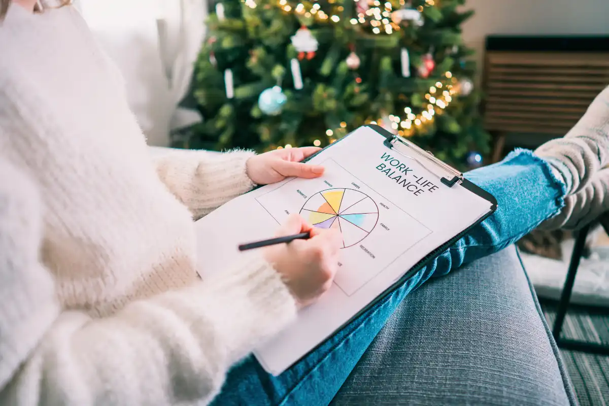 woman near a christmas tree planning for her recovery during holiday