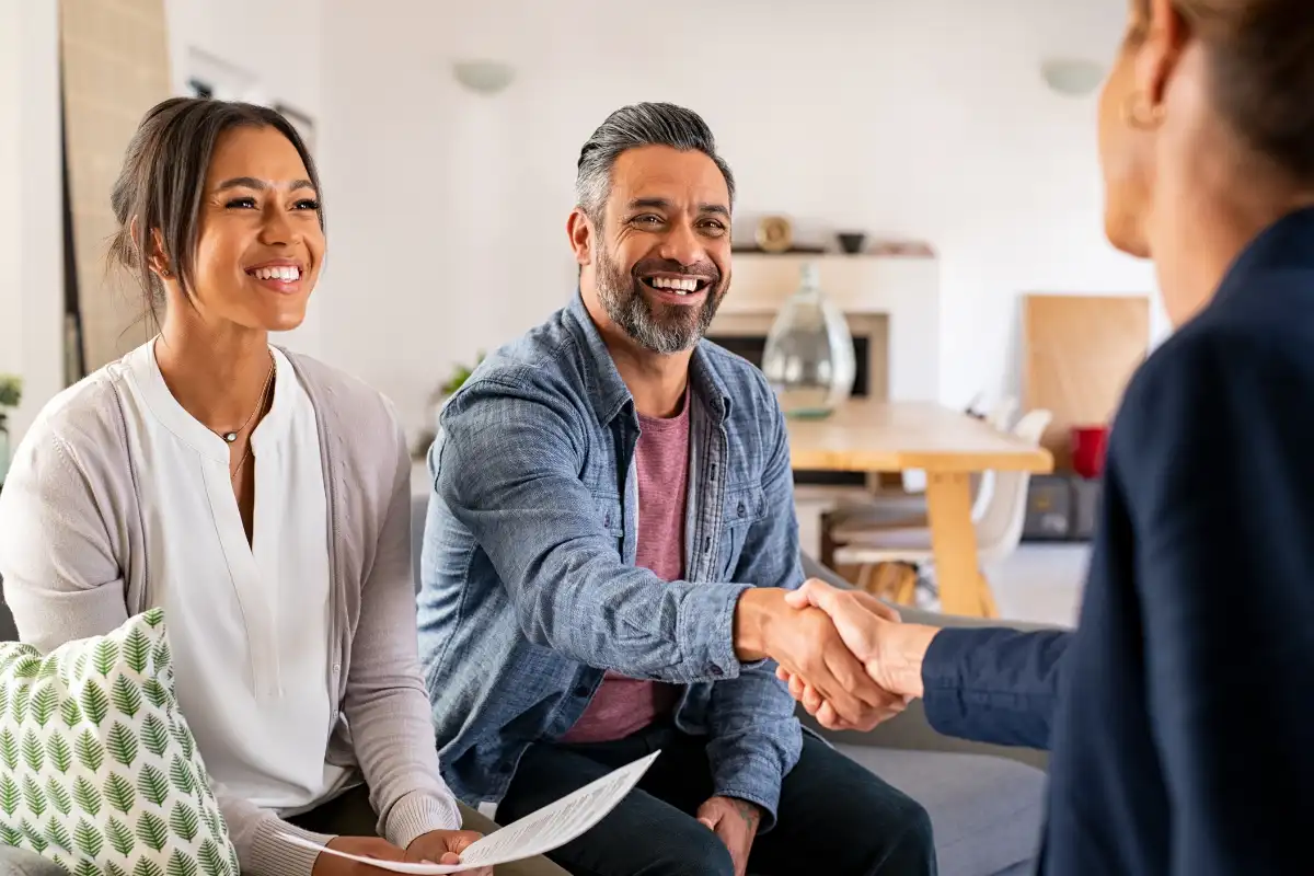 Couple Handshaking with Consultant at Home