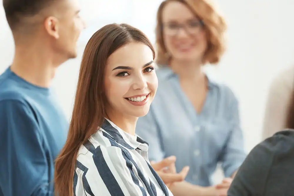 a family member of a client smiling for camera during family intervention