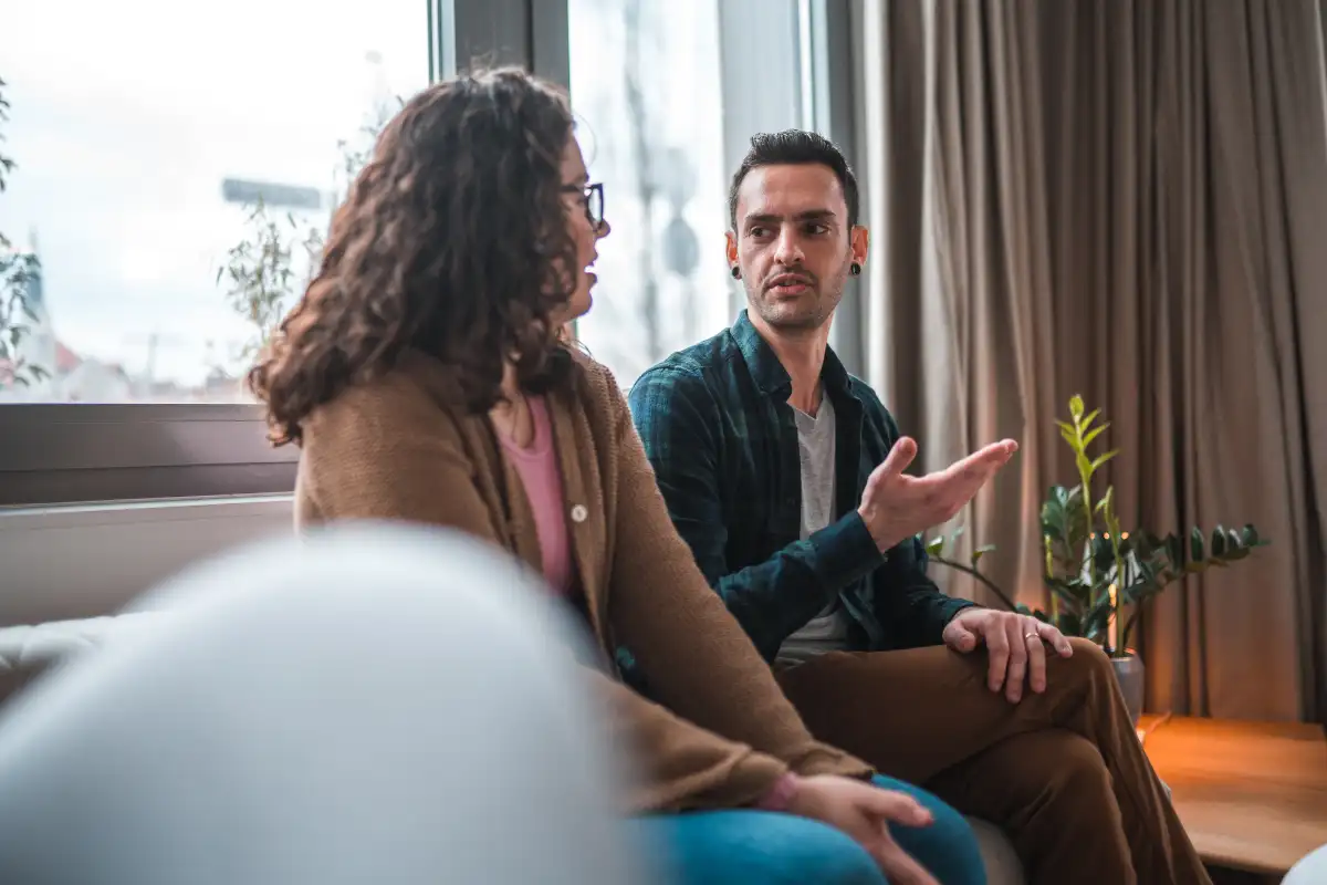 a man and a woman sitting in the living room