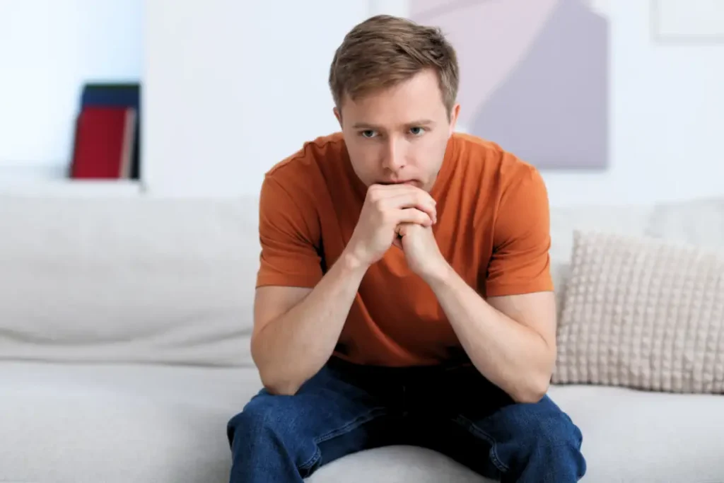 Thoughtful Man on Sofa at Home (1)