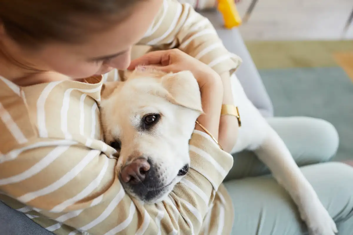 Woman Cuddling with Dog