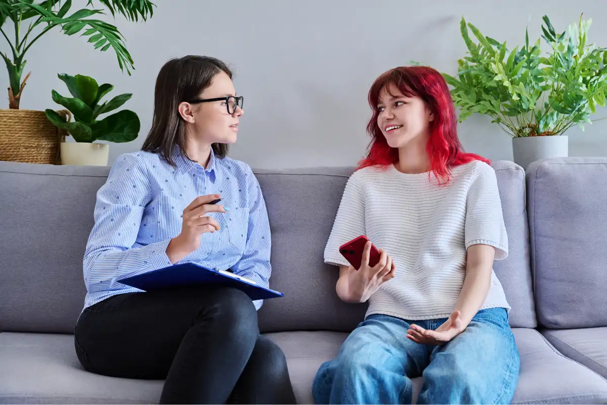 Psychologist Counseling Teenage Female, Individual in Doctors Office.