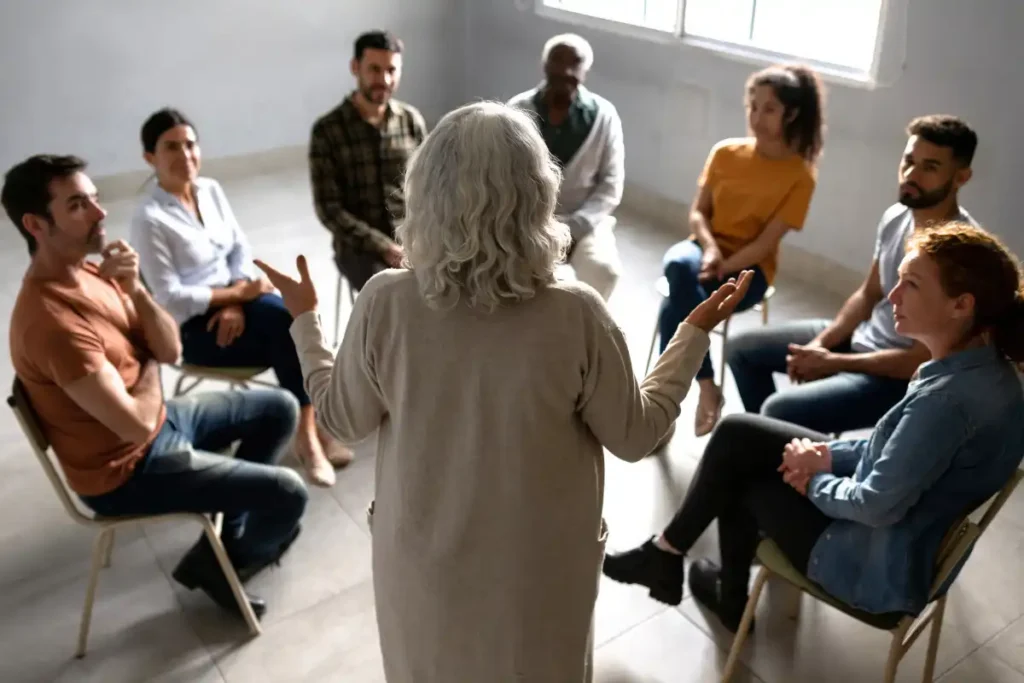 Therapist guiding a group therapy session