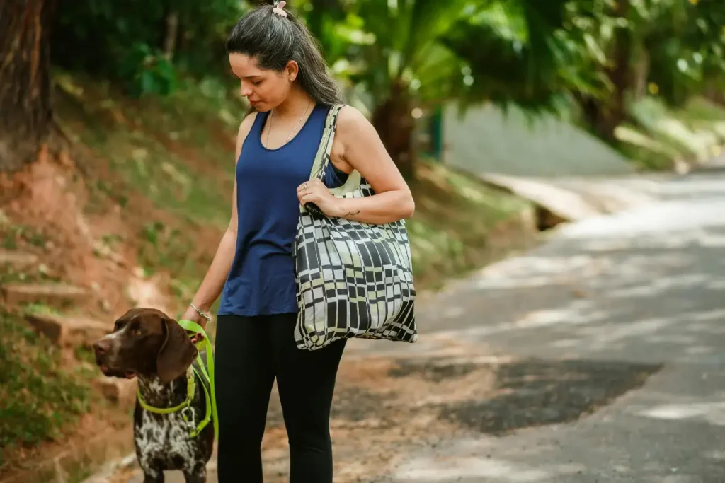 Woman Walking Dog in Tropical Park