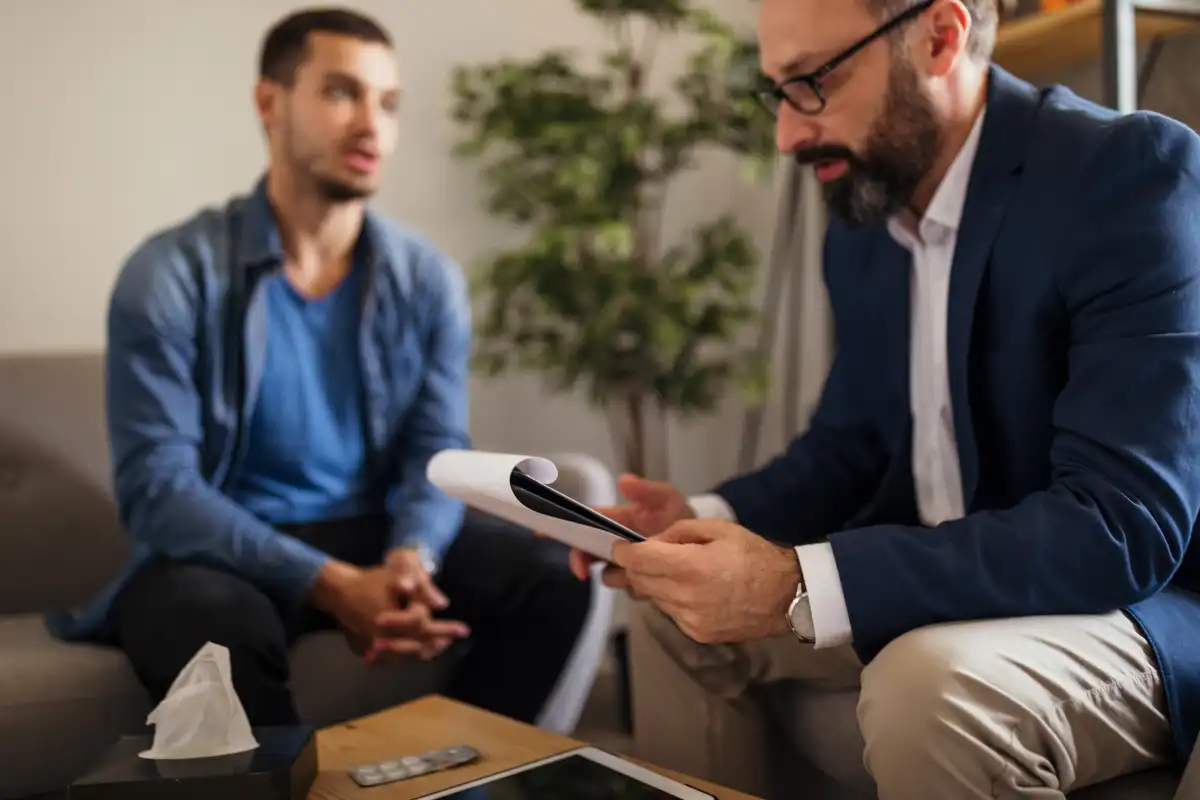 a man and a male psychologist during individual therapy