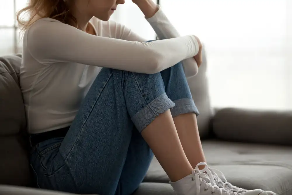 Upset Young Woman Sitting on a Couch