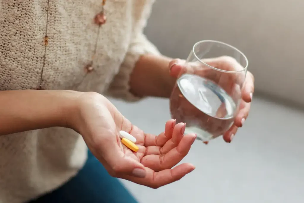a woman with vitamins in her hand
