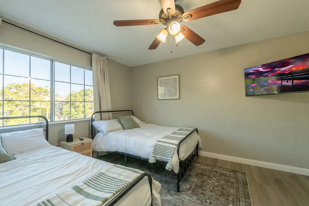 two bedroom with television at West Coast Detox